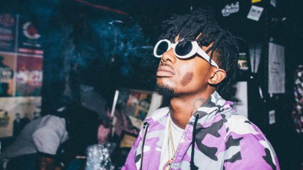 Free playboi carti is looking up wearing purple and black coat with white tshirt and goggles hd music wallpaper download