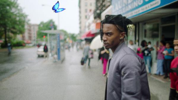 Free playboi carti is standing in blur crowd background wearing ash coat facing one side hd music wallpaper download