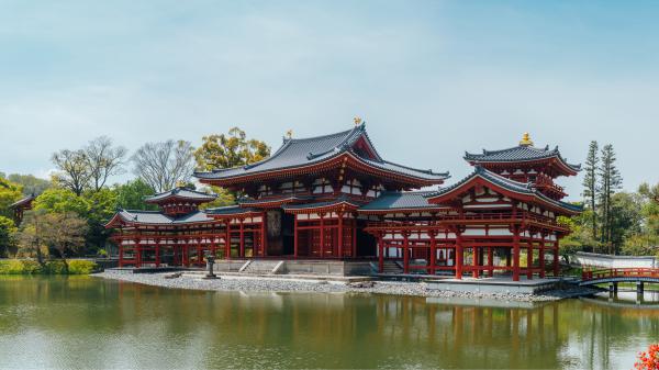 Free religious temple near river around green trees in a sky background 4k 5k hd travel wallpaper download