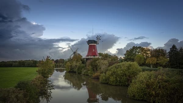 Free river between windmill and grass field in germany 4k 5k hd travel wallpaper download