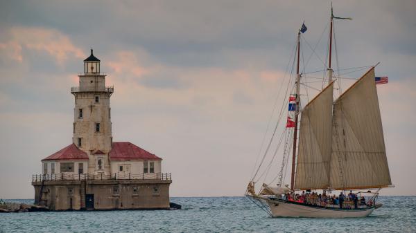 Free sailboat on sea and lighthouse in the middle of sea in michigan hd travel wallpaper download