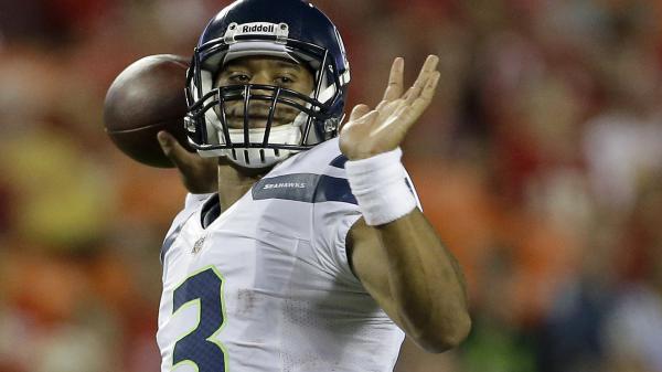 Free seattle seahawks russell wilson is throwing ball with shallow background hd seattle seahawks wallpaper download