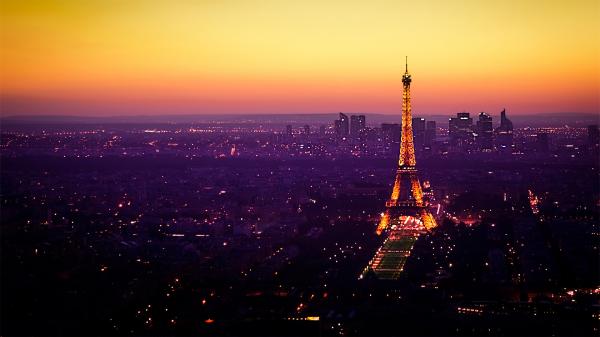 Free shimmering paris eiffel tower with yellow sky background during sunset hd travel wallpaper download