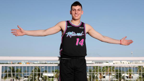 Free smiley cute tyler herro is showing hands in the air wearing black dress while posing for a photo in a scenery background basketball hd sports wallpaper download