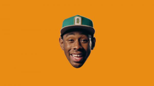 Free smiley tyler the creator head in yellow background wearing green cap hd music wallpaper download