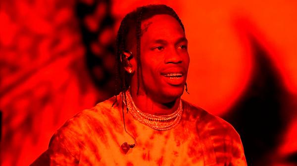 Free travis scott in red background wearing gold chains on neck and studs hd travis scott wallpaper download