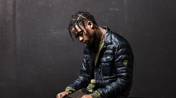 Free travis scott is looking down wearing black overcoat in black background hd travis scott wallpaper download