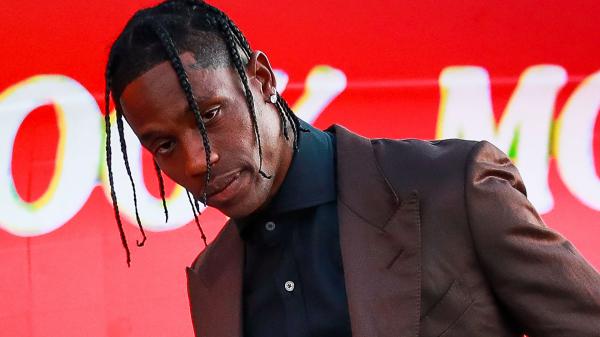 Free travis scott is wearing black shirt and brown coat and stud on ear hd travis scott wallpaper download