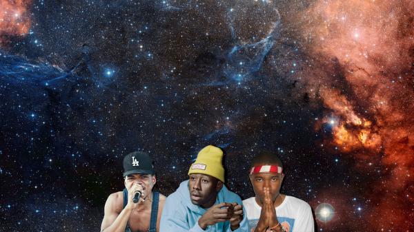 Free tyler the creator in a colorful starry background wearing yellow cap and blue cap tshirt facing one side with two people near 4k hd music wallpaper download