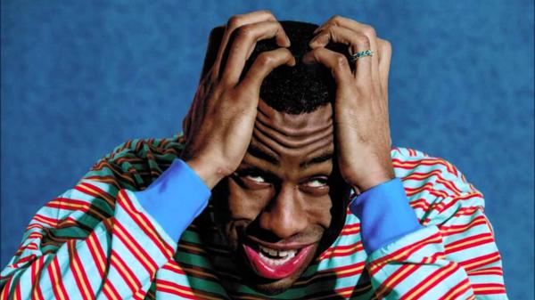 Free tyler the creator is having hands on head in a blue background hd music wallpaper download