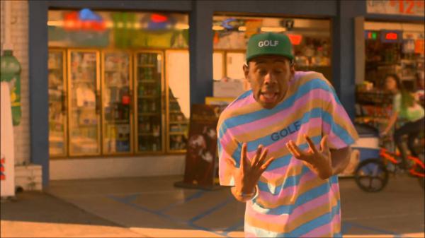 Free tyler the creator is standing in a store background with eyes closed hd music wallpaper download