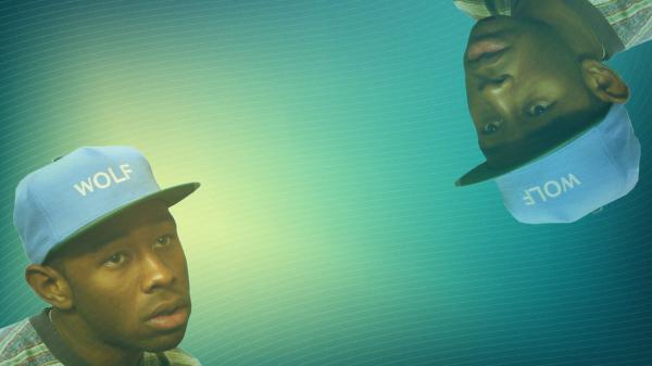 Free tyler the creator is wearing wolf word blue cap in a blue background hd music wallpaper download