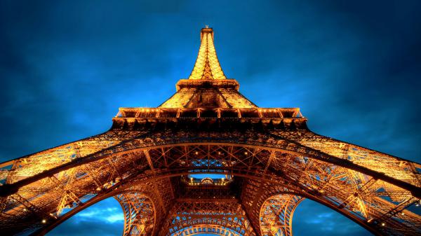 Free upward view of yellow lighting paris eiffel tower with blue sky background hd travel wallpaper download