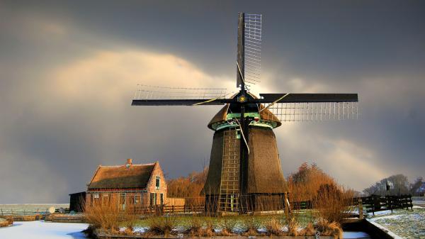 Free windmill surrounded by fence in netherlands hd travel wallpaper download