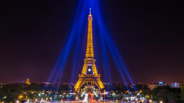 Free yellow lighting paris eiffel tower around blue lights with black sky background hd travel wallpaper download